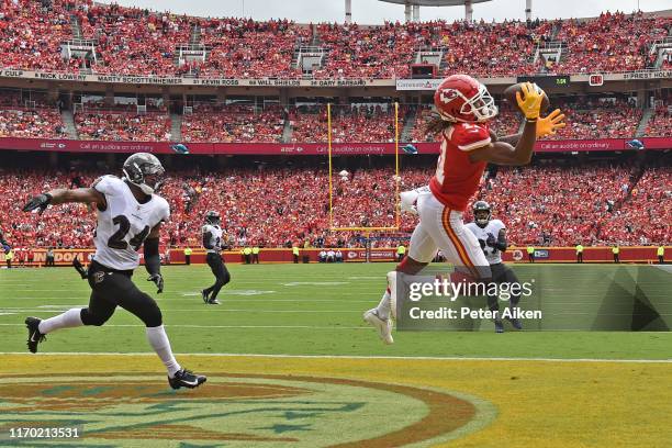 Wide receiver Demarcus Robinson of the Kansas City Chiefs catches a touchdown pass against cornerback Brandon Carr of the Baltimore Ravens during the...