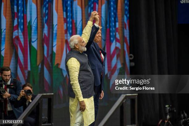 Indian Prime Minster Narendra Modi and U.S. President Donald Trump raise clasped hands onstage at NRG Stadium during a rally on September 22, 2019 in...