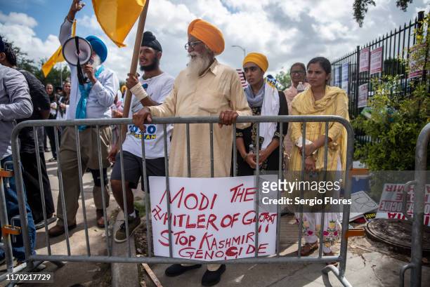 Protesters chant and wave flags outside after a rally attended by Indian Prime Minister Narendra Modi at NRG Stadium on September 22, 2019 in...