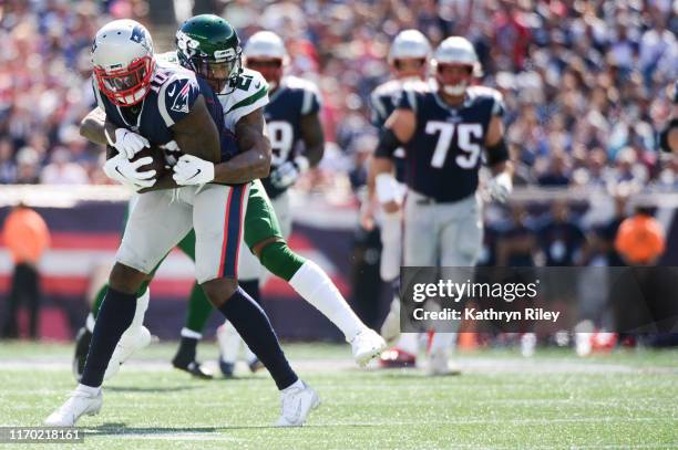 Josh Gordon of the New England Patriots is tackled by Trumaine Johnson of the New York Jets in the first quarter at Gillette Stadium on September 22,...