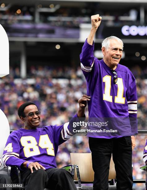Former quarterback Joe Kapp acknowledges the crowd as former teammate Gene Washington looks on as the Minnesota Vikings honor their 1969 team during...