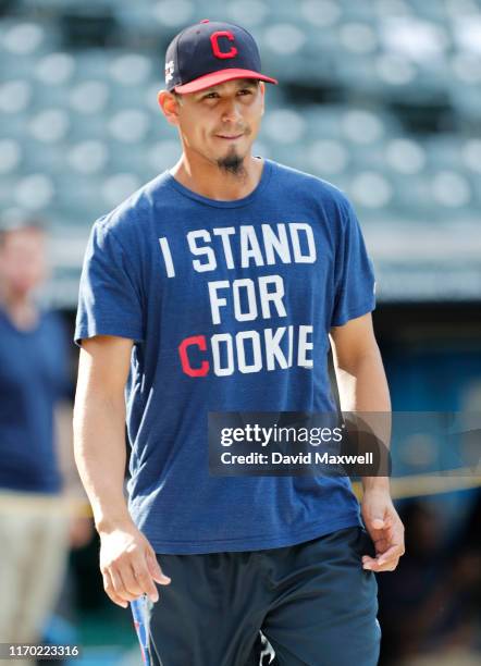 Carlos Carrasco of the Cleveland Indians walks from the dugout wearing an "I Stand for Cookie" t-shirt during pregame warm ups before the game...