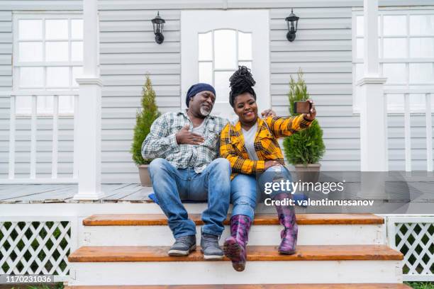 father and daughter hanging out on the porch. - new deck stock pictures, royalty-free photos & images