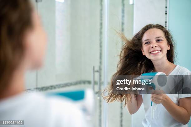 morgenroutine eines teenagers - drying hair stock-fotos und bilder