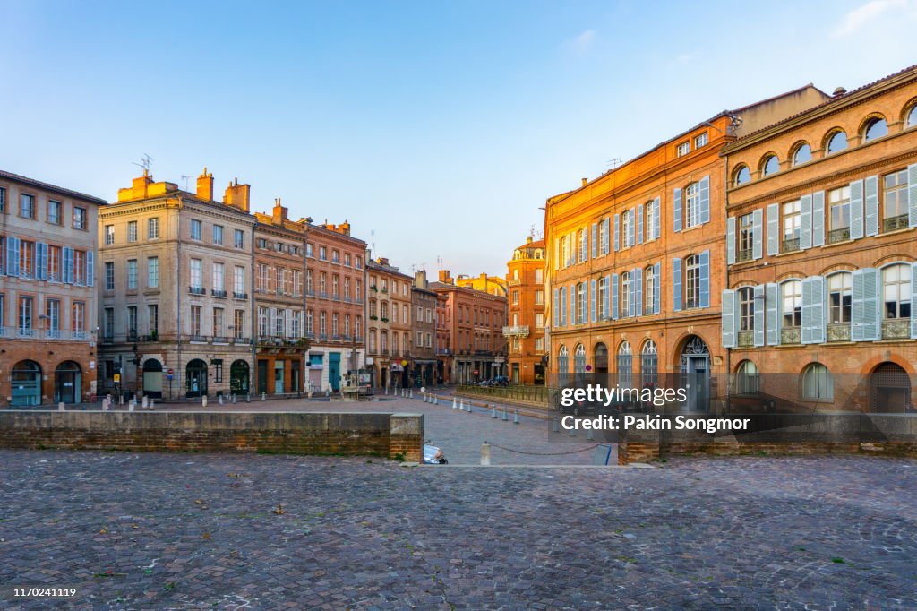 Narrow historic street with old buildings in Toulouse