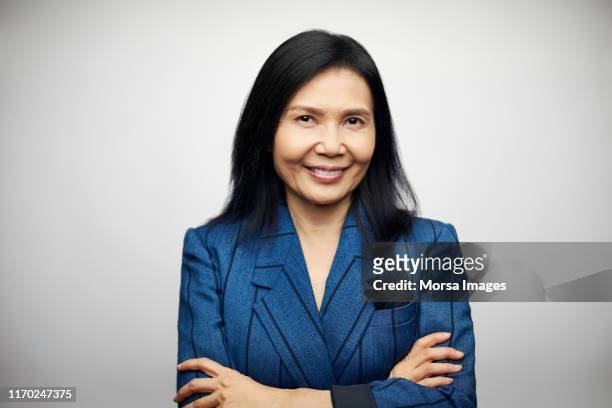 confident smiling mature executive in blazer - blue blazer stock pictures, royalty-free photos & images