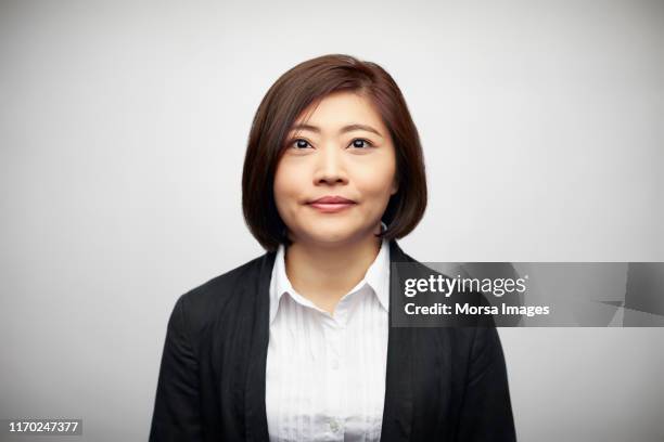 portrait of businesswoman against white background - woman shirt stock pictures, royalty-free photos & images