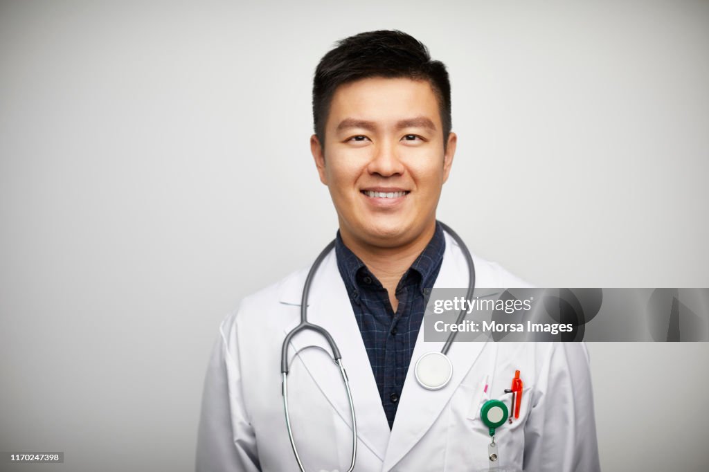 Portrait of confident male doctor in lab coat