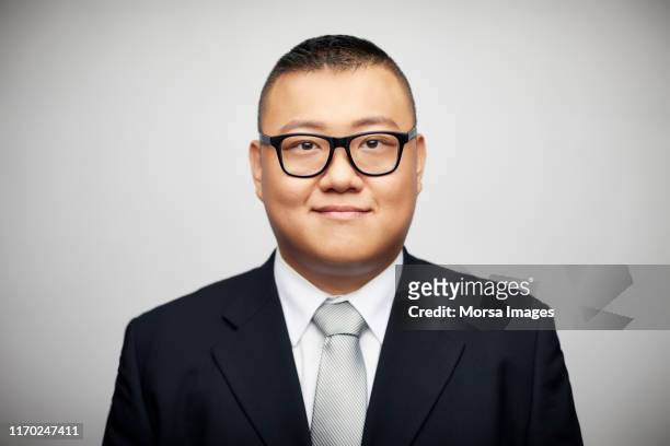 confident mid adult male executive wearing suit - male portrait white background stock-fotos und bilder