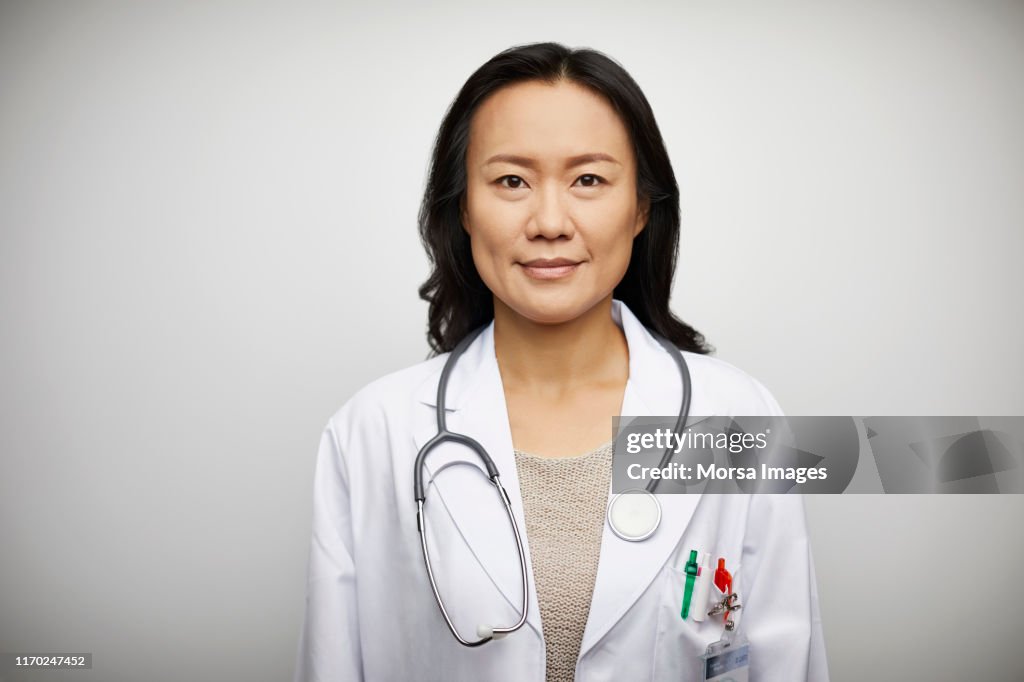Confident portrait of female doctor in lab coat