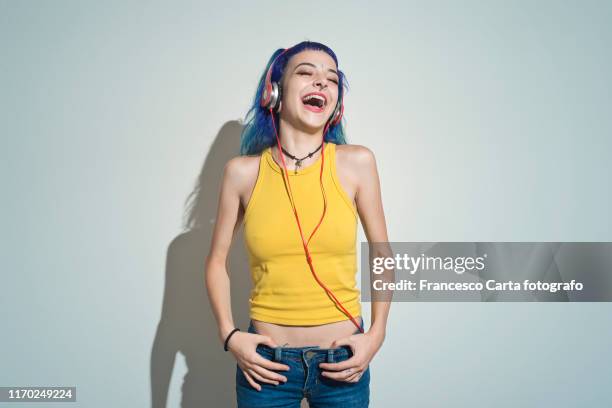 young girl listening to music - girl with blue hair stock pictures, royalty-free photos & images