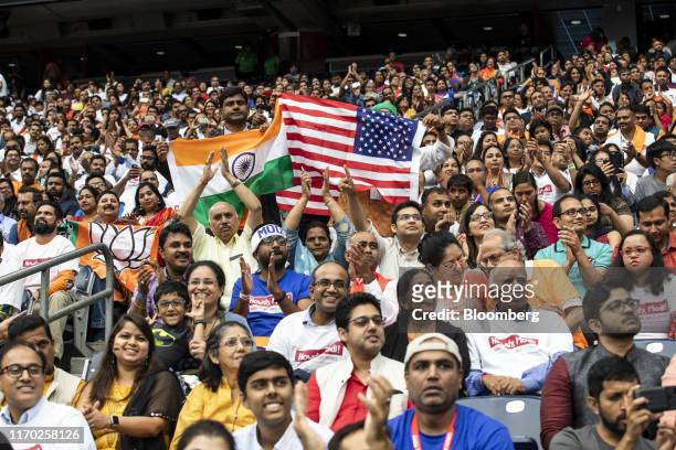 Attendees listen as U.S. President Donald Trump, not pictured, speaks during the Howdy Modi Community Summit For Indian Prime Minister Narendra Modi...