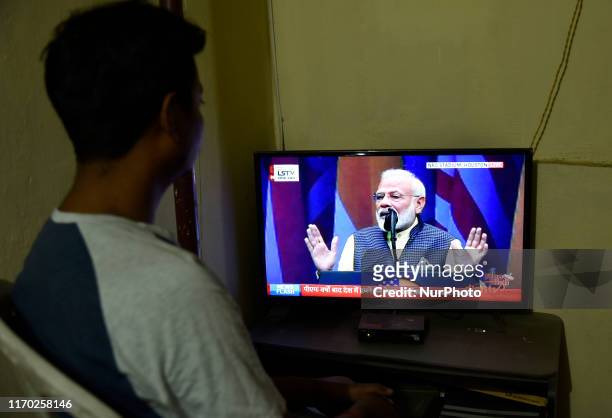 Man watching live broadcast on television of Prime Minister Narendra Modi addresses a mega Howdy, Modi gala event, in Guwahati, Assam, India on 22...