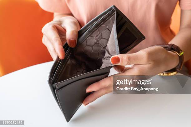 close-up of woman hands open an empty wallet, bad economics situation. - ficka bildbanksfoton och bilder