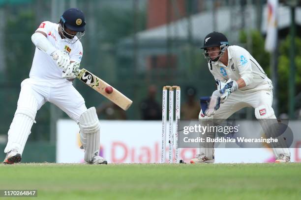 Dimuth Karunaratne of Sri Lanka hits out Bradley-John Watling of New Zealand field during the day five of the Second Test match between Sri Lanka and...