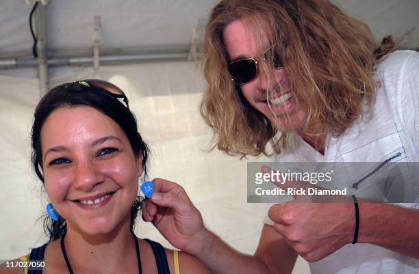 Former American Idol Bucky Covington backstage points out his Bucky Covington earing collecton made by himself with Guitar picks during the First...