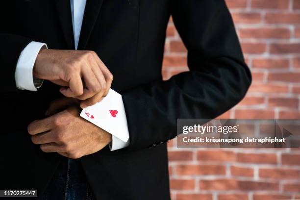 business man with ace in his sleeve.,business goals concept,business growth,goals - goocheltruc stockfoto's en -beelden