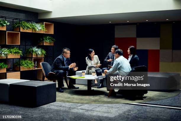 colleagues discussing during meeting in office - taiwan business stock pictures, royalty-free photos & images