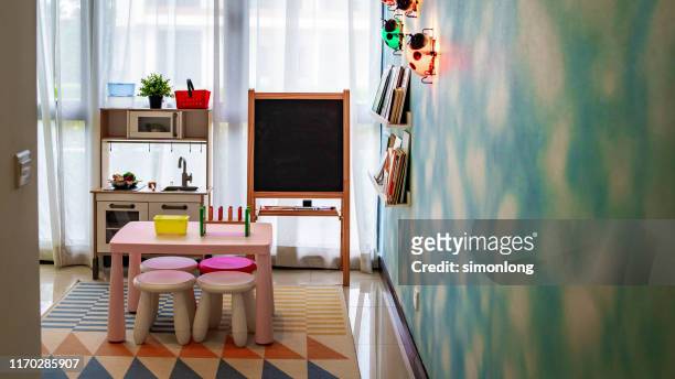 kids playroom with table and blackboard - cuarto de jugar fotografías e imágenes de stock