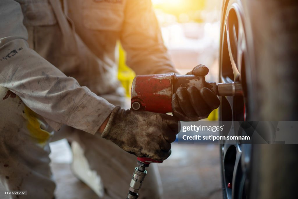 Automotive technicians repair the tires or take off the wheels.
