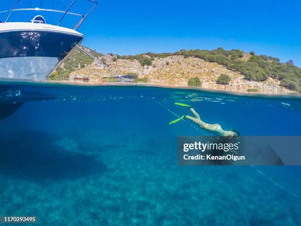 daily boat trip. woman floating in a daily boat tour. - ölüdeniz stock pictures, royalty-free photos & images