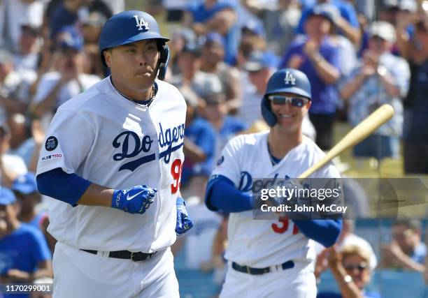 Joc Pederson of the Los Angeles Dodgers smiles as Hyun-Jin Ryu runs to the dugout after Ryu hits the first home run of his career in the fifth inning...
