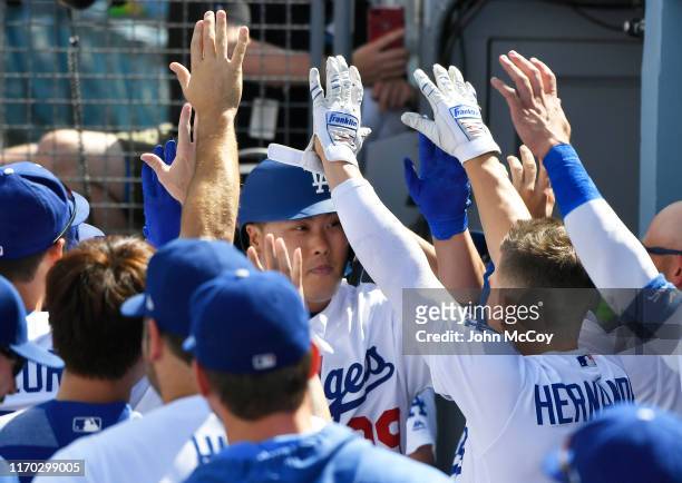 Hyun-Jin Ryu of the Los Angeles Dodgers is congratulated in the dugout after hitting the first home run of his career in the fifth inning against the...