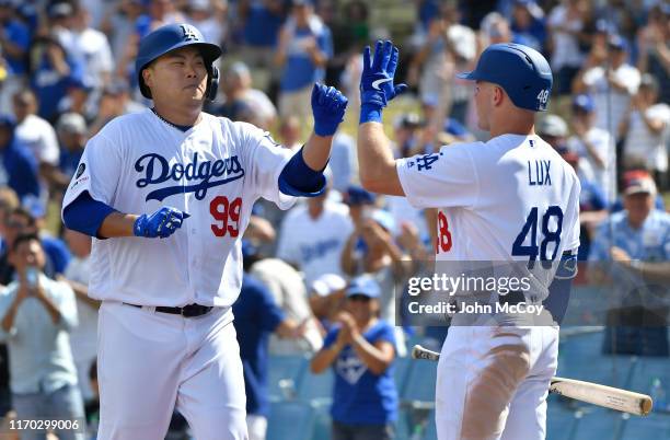 Hyun-Jin Ryu of the Los Angeles Dodgers is congratulated by Gavin Lux after hitting the first home run of his career in the fifth inning against the...