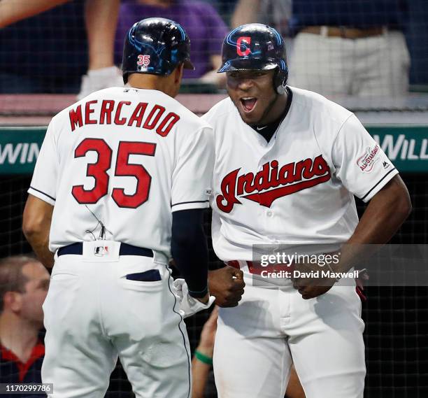 Oscar Mercado of the Cleveland Indians celebrates his three run home run against the Philadelphia Phillies with Yasiel Puig as he returns to the...