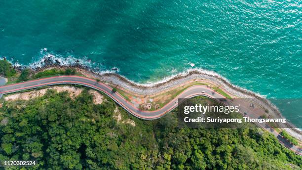 aerial top view highway road along the sea. - crossroad top view stockfoto's en -beelden