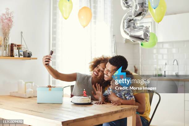 family taking selfie during birthday celebration - baby number 2 stock pictures, royalty-free photos & images