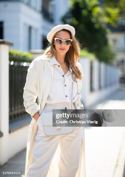 Alexandra Lapp wearing a white vintage trench coat, white American Vintage overall, white vintage wool beret, white Céline medium classic box flap...