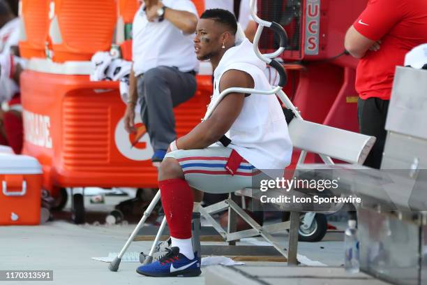 Saquon Barkley of the Giants has a high ankle sprain and wears a boot along the sideline during the regular season game between the New York Giants...