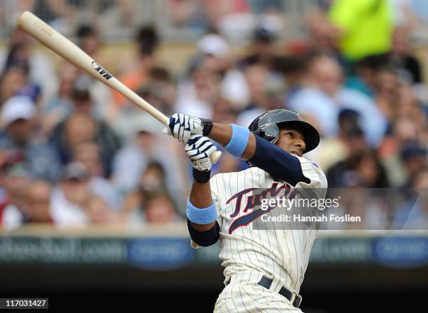 Alexi Casilla of the Minnesota Twins hits a solo home run against the San Diego Padres in the first inning on June 19, 2011 at Target Field in...