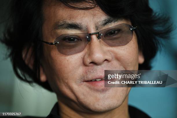 This photo taken on June 16, 2019 shows robotician Hiroshi Ishiguro posing at his research centre in Osaka. - Set in 2019, cult 80s movie "Blade...