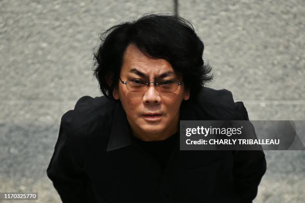 This photo taken on June 16, 2019 shows robotician Hiroshi Ishiguro posing at his research centre in Osaka. - Set in 2019, cult 80s movie "Blade...