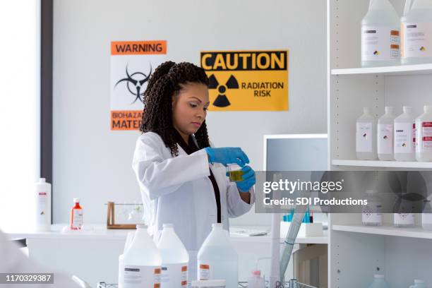 mid adult scientist prepares samples for testing - radiation sickness stock pictures, royalty-free photos & images