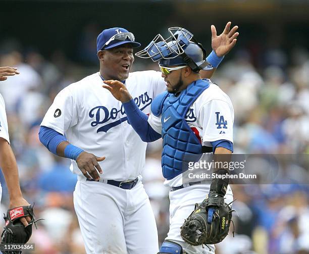 Catcher Dioner Navarro of the Los Angeles Dodgers is congratulated by Juan Uribe after the game with the Houston Astros on June 19, 2011 at Dodger...