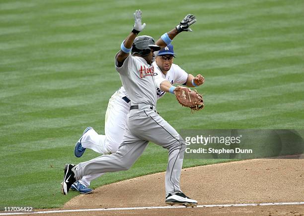 First baseman James Loney of the Los Angeles Dodgers tags out Michael Bourn of the Houston Astros on a ground ball in the third inningon June 19,...