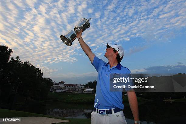 Rory McIlroy of Northern Ireland poses with the trophy after his eight-stroke victory on the 18th green during the 111th U.S. Open at Congressional...