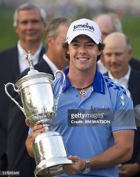 Rory McIlroy of Northern Ireland holds his trophy after winning the 111th US Open by eight strokes over Jason Day with a record 268 at Congressional...