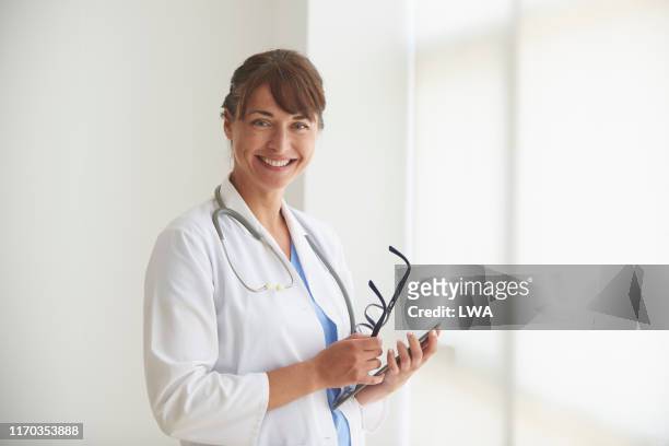 portrait of a female doctor. - clinic stock pictures, royalty-free photos & images