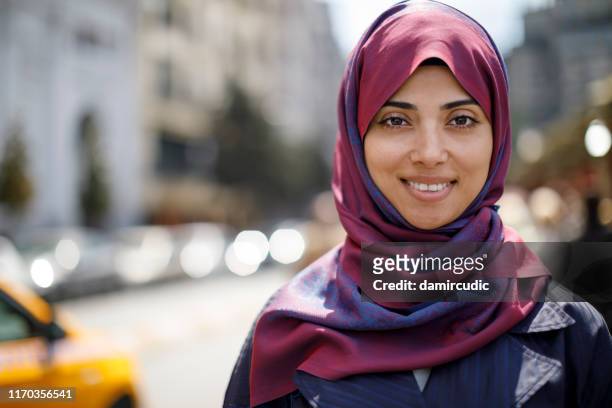 portrait of smiling muslim woman in the city - beautiful arabian girls stock pictures, royalty-free photos & images