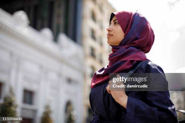 junge muslimische frau auf reisen - arab woman walking stock-fotos und bilder