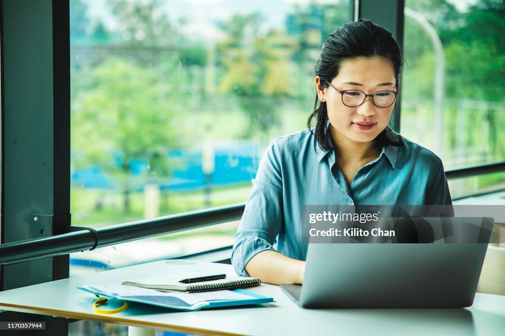 Asian woman working on a laptop