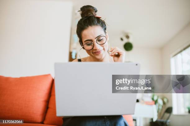 woman working online on laptop at home - indian ethnicity laptop stock pictures, royalty-free photos & images