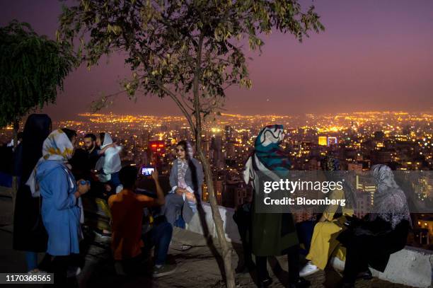 Visitors view the illuminated city skyline from a terrace at the Bam-e Tehran stone wall in Tehran, Iran, on Friday, Sept. 20. 2019. Iranian Foreign...