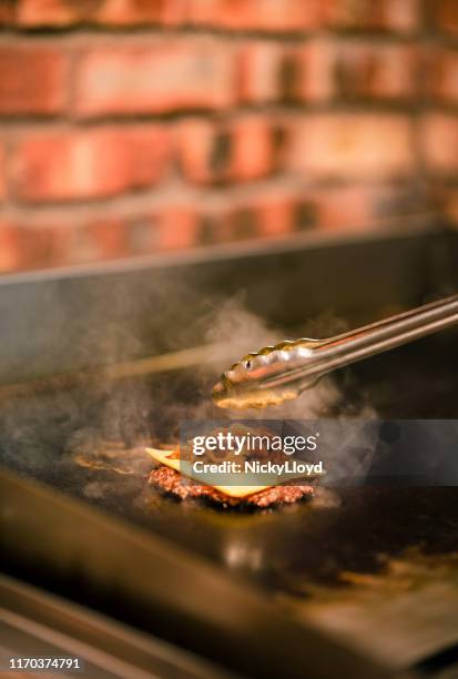 cooking a hamburger - nicky turner stock pictures, royalty-free photos & images