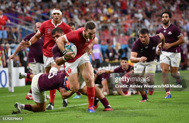 Wales' George North evades the tackle of Georgia's Soso Matiashvili to score his sides sixth try during the Rugby World Cup 2019 Group D game between...