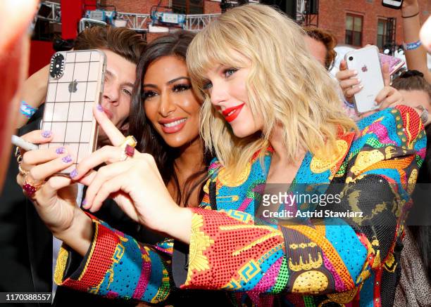Taylor Swift takes a selfie with a fan during the 2019 MTV Video Music Awards at Prudential Center on August 26, 2019 in Newark, New Jersey.